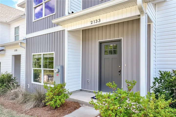 A welcoming entry framed by neatly maintained shrubs offers immediate curb appeal.