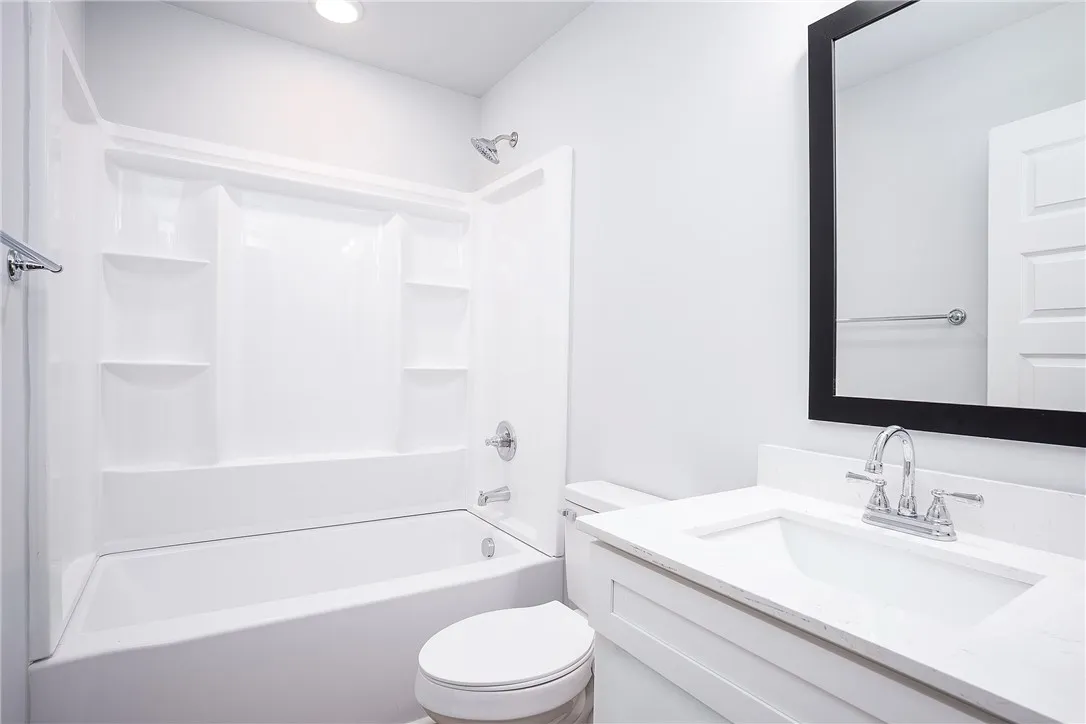 A well-appointed bath features a sleek vanity and a tub-shower combination for daily rejuvenation.