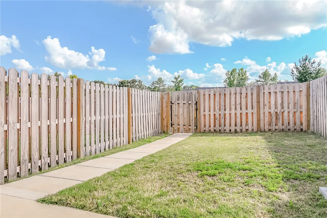 A fully fenced backyard with a secure gate, perfect for privacy and outdoor enjoyment.