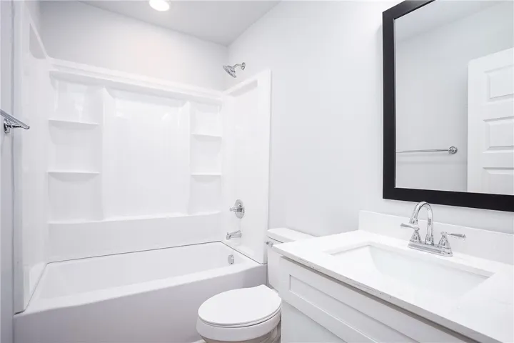A well-appointed bath features a sleek vanity and a tub-shower combination for daily rejuvenation.