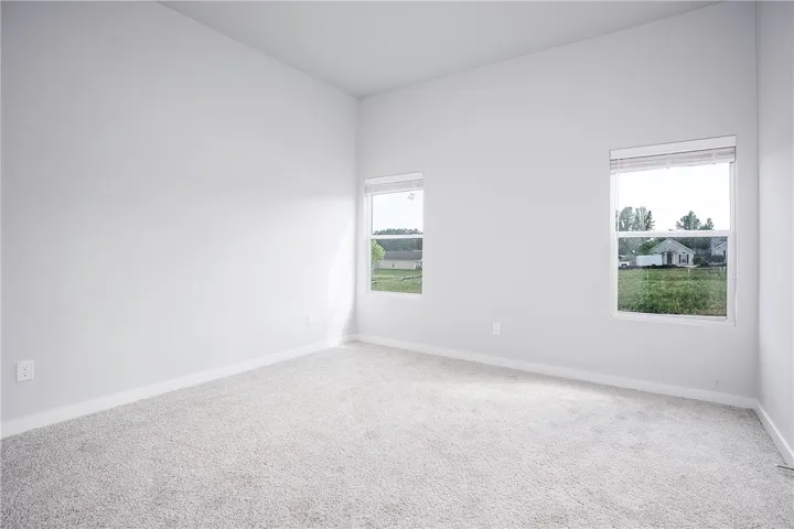 A spacious and pristine interior, ready for personalization, offers views of the surrounding neighborhood through two well-placed windows.