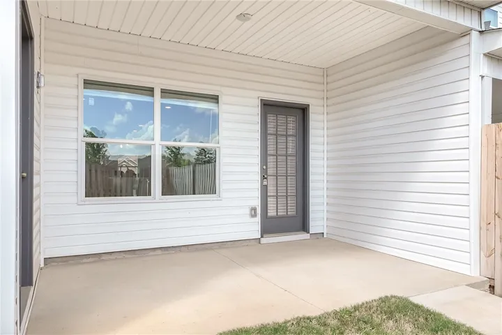 A private concrete patio extends from the house, offering space for outdoor enjoyment.