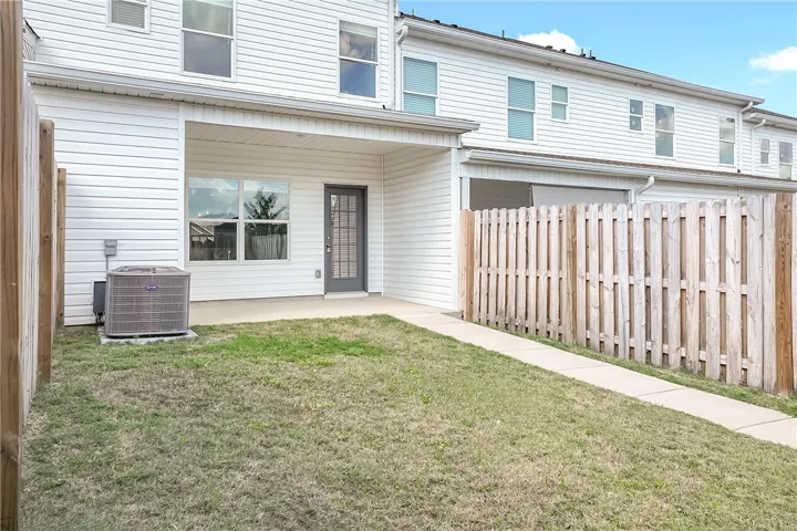 A private fenced backyard with a patio offers a serene outdoor retreat.