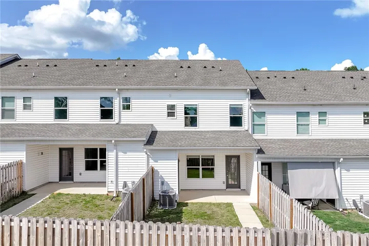 A well-maintained row of townhomes with private fenced yards offers comfortable living.