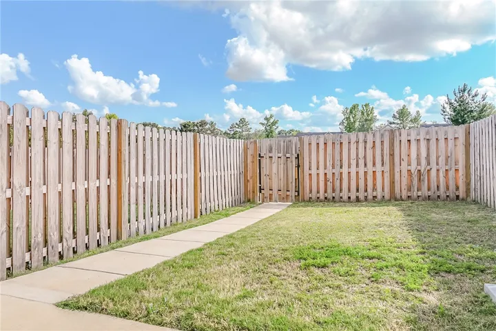 A fully fenced backyard with a secure gate, perfect for privacy and outdoor enjoyment.