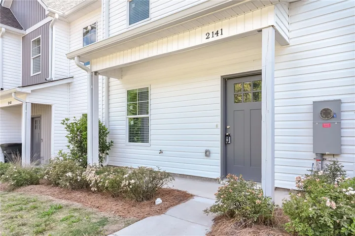 A welcoming front entrance with a covered porch and neatly maintained landscaping.