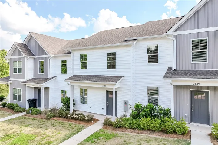 Clean lines and classic siding define this charming row of townhomes.