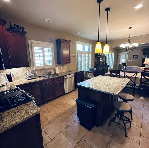 Culinary delights await in this well-appointed kitchen, featuring a central island and a seamless connection to the dining area.