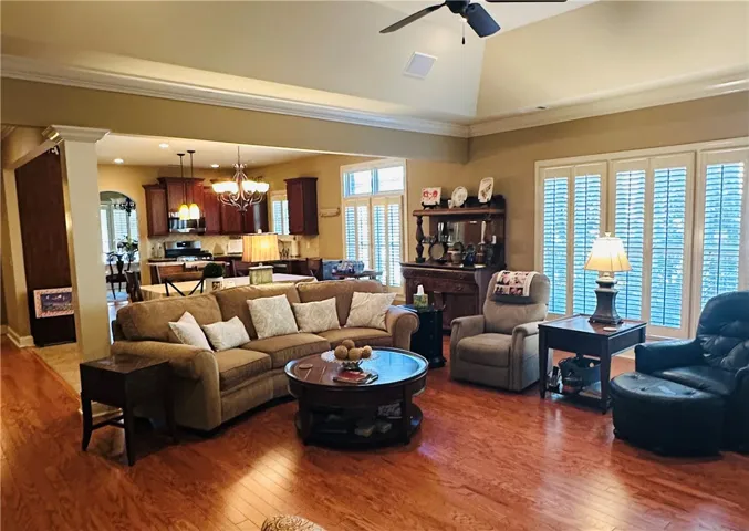An open floorplan seamlessly connects the inviting living space to a modern kitchen, creating an ideal setting for gatherings.