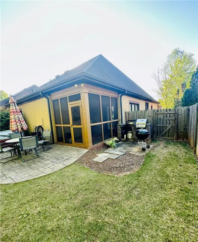 A well-maintained lawn and paved patio provide ample space for outdoor enjoyment.