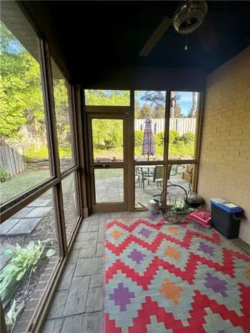 A tranquil screened porch invites outdoor enjoyment, overlooking a private yard with additional patio space.