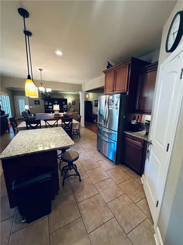 An inviting kitchen seamlessly transitions to a dining area and living room, perfect for entertaining.