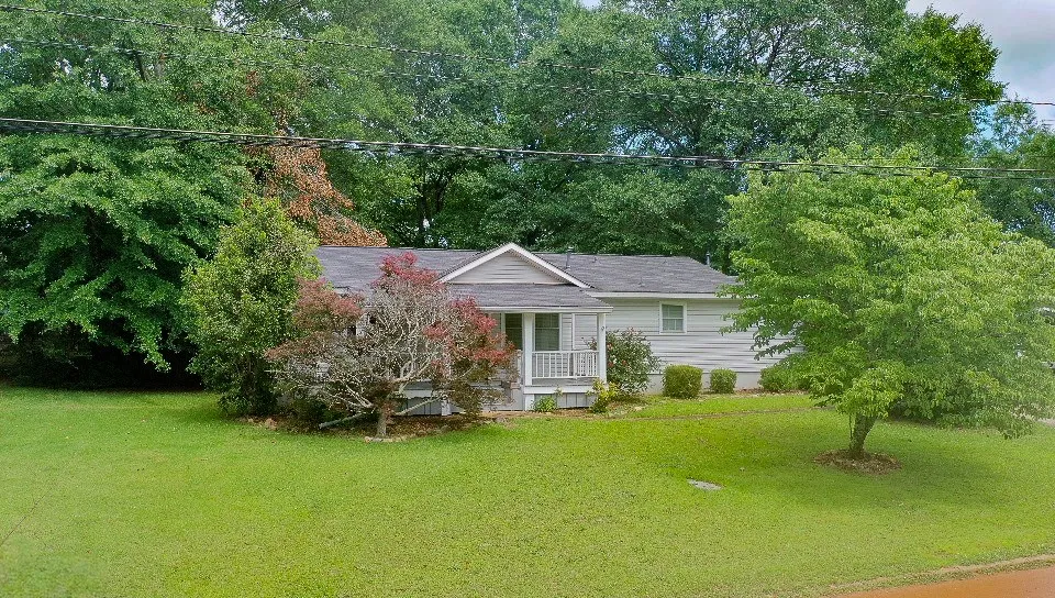 A well-maintained facade with a welcoming porch offers pleasant curb appeal.