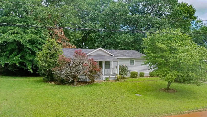 A well-maintained facade with a welcoming porch offers pleasant curb appeal.