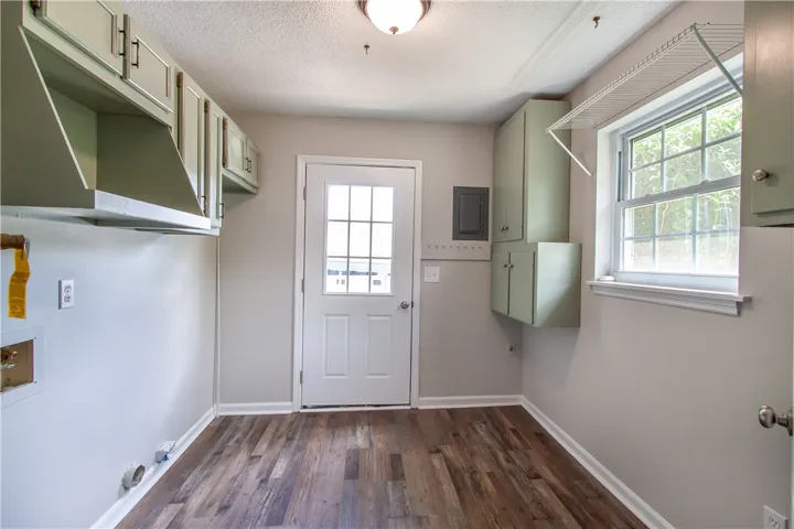 Ample cabinetry provides essential storage within this functional laundry space.
