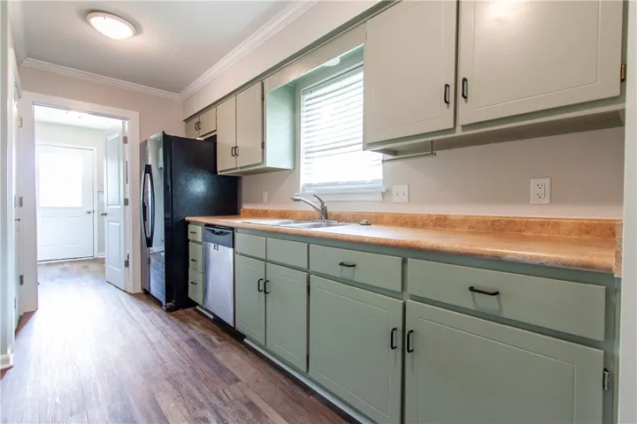 Functional kitchen with ample cabinetry and resilient laminate countertops.