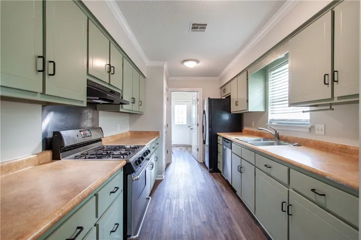 A well-equipped galley kitchen offers ample cabinet storage and modern appliances.