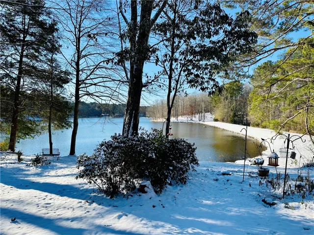 A lakeside scene blanketed in fresh snow