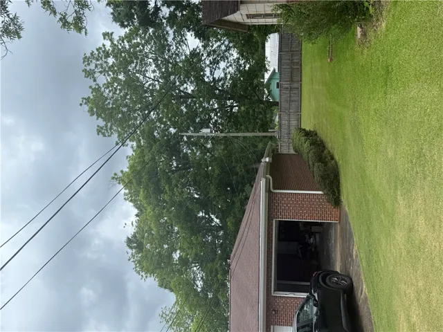 A well-maintained lawn and sturdy brick garage define this property's exterior.