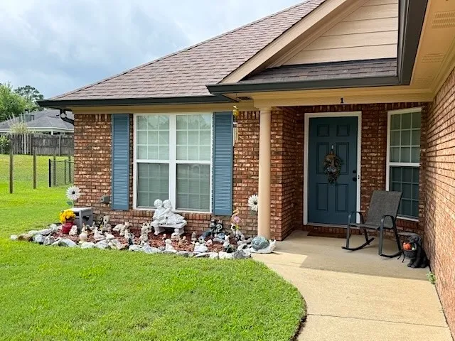A classic brick exterior offers timeless appeal and a welcoming front porch entry.
