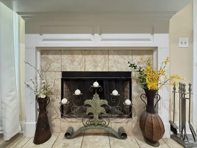 A refined fireplace with an elegant mantelpiece adds warmth and charm to the living space.