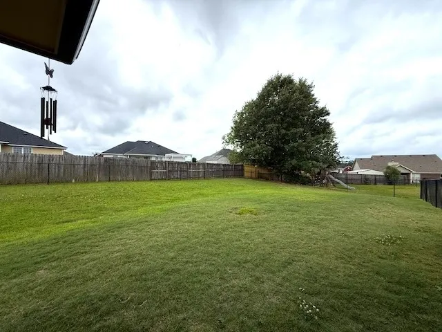 A spacious, enclosed yard provides ample room for recreation and outdoor enjoyment.
