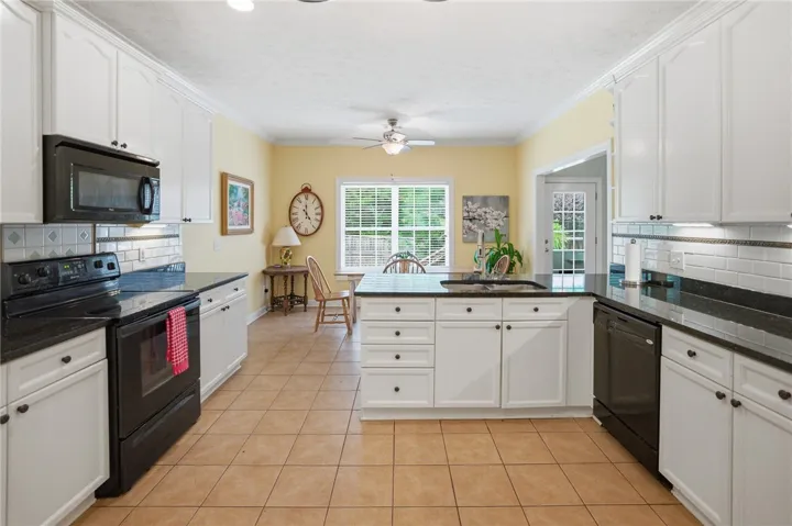 Culinary adventures await in this bright kitchen, complete with a functional island.