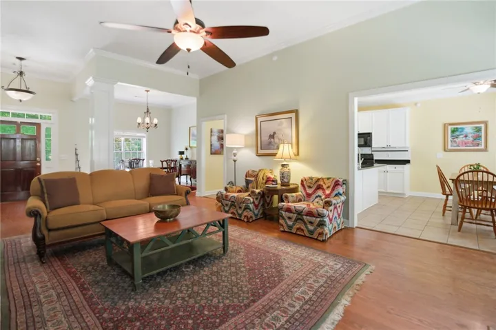 Hardwood floors and generous crown molding define this welcoming living space.