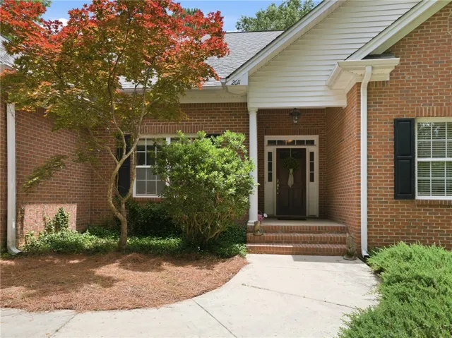 A well-maintained brick exterior welcomes guests to this inviting residence.