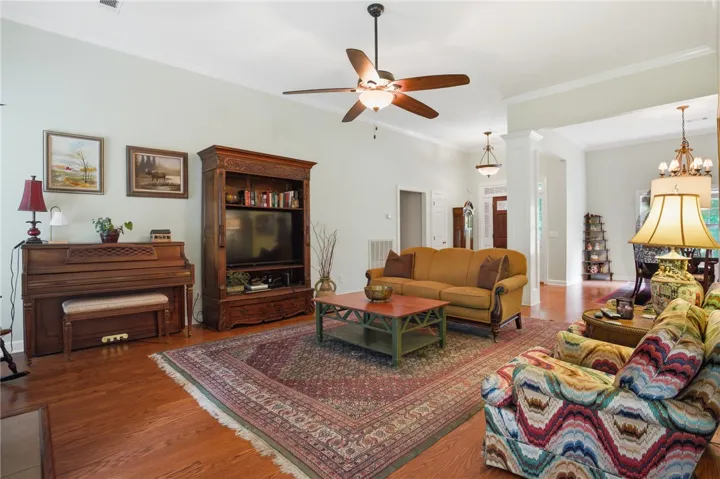 Hardwood floors and generous ceiling heights characterize this inviting living room.