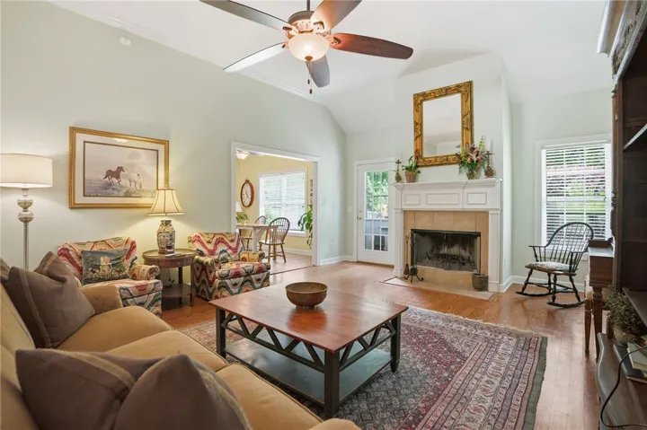A comforting living area features a grand fireplace, creating an inviting atmosphere.
