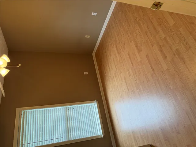 High ceilings and durable laminate flooring create a spacious and inviting atmosphere.