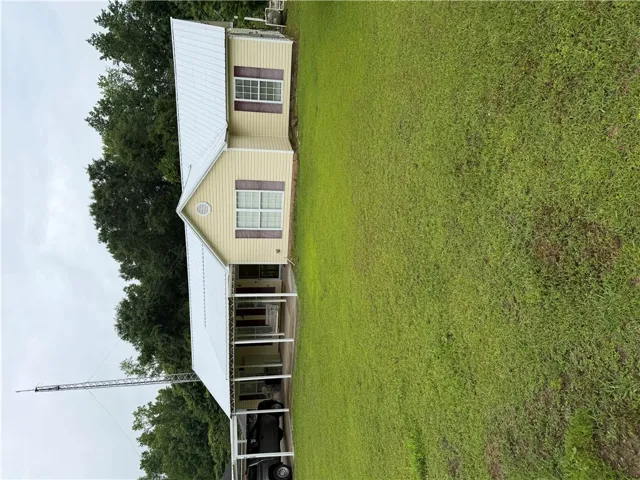 A well-maintained home with a charming front porch, set on a verdant lot.
