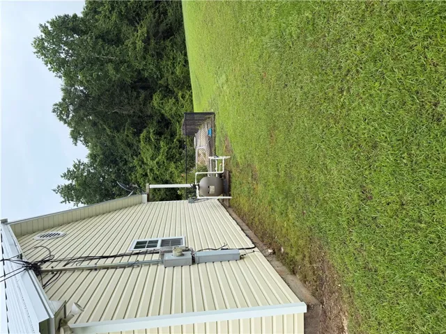A verdant lawn gracefully meets the structure, offering ample space for outdoor pursuits.
