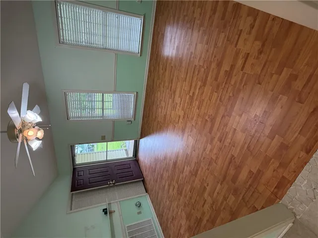 An inviting entry space features LVP flooring and a bright ceiling fan.