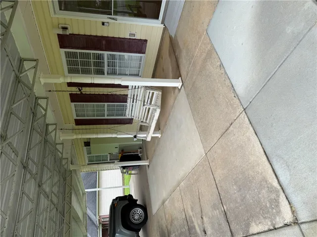 A welcoming front porch features a charming swing, inviting relaxation and outdoor enjoyment.