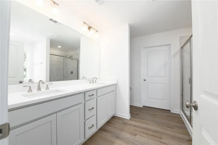 Clean lines and a spacious dual vanity define this modern, light-filled bathroom.
