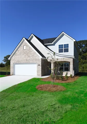 Multi-textured siding, brick accents, and architectural gables define this handsome contemporary home exterior.