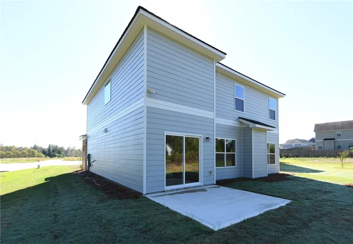 Clean lines and a concrete patio define this modern two-story exterior design.
