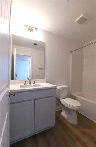 A modern vanity with stone counters and a neutral color palette highlights this bathroom.