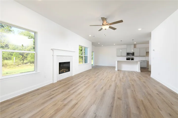 Clean lines and a modern fireplace anchor this expansive, open-concept living space.