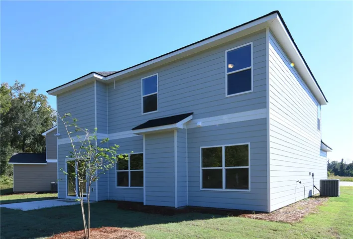 Crisp horizontal siding and clean lines define the exterior of this modern two-story home.