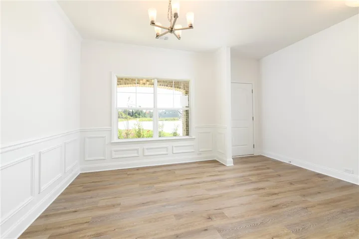 Elegant wainscoting and warm wood-look floors define this versatile dining area.