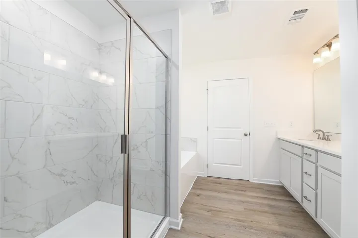 Clean lines and a spacious tile shower define this modern, well-appointed bathroom.