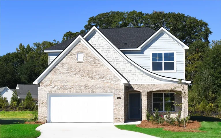 Multi-textured siding and brick accent the facade of this two-story traditional home.