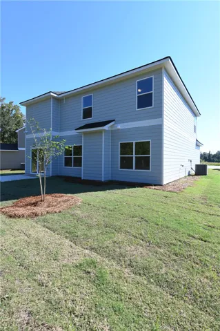 Modern siding and large windows define the clean lines of this two-story rear exterior.