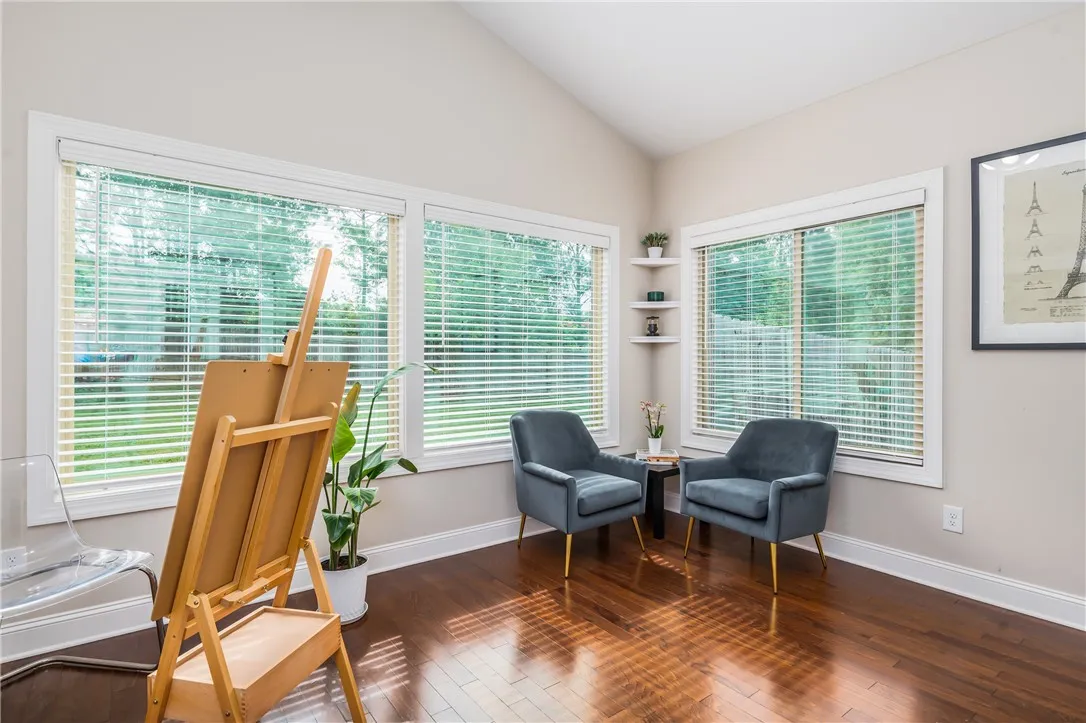 Hardwood floors and generous window lighting define this inviting study.