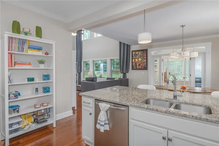 Granite counters and stainless steel appliances adorn this kitchen with a bright, open-concept living area.
