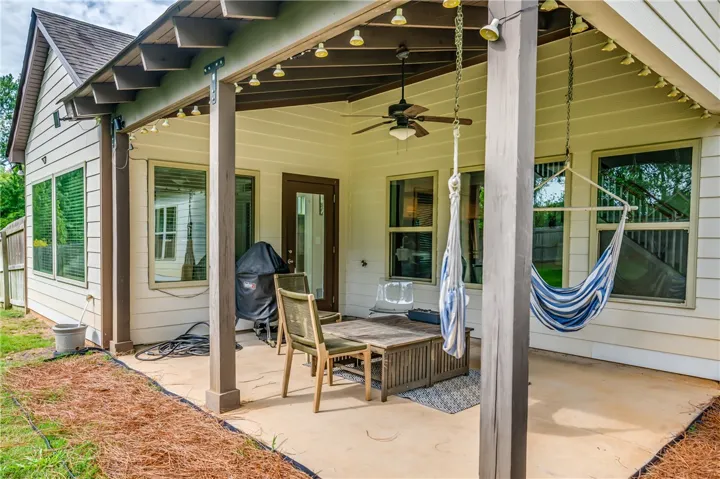 A spacious concrete patio offers outdoor relaxation with hammocks and ample seating.