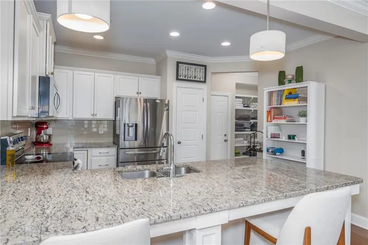 A gourmet kitchen offers granite countertops and stainless steel appliances, perfect for culinary endeavors.
